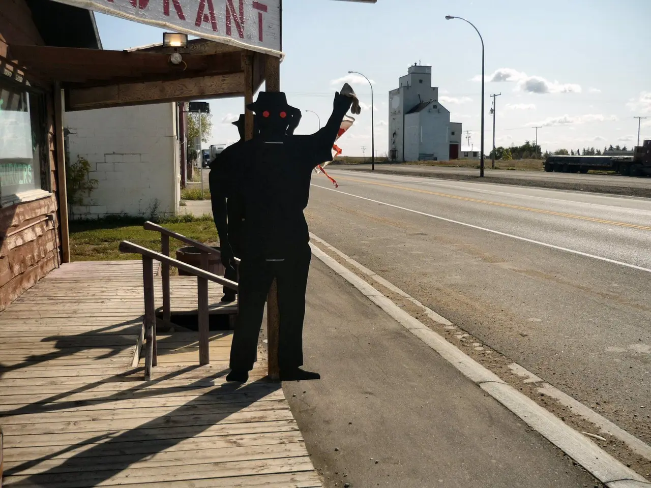 Plywood figure outside restaurant on Highway 11 with grain elevator, 2008